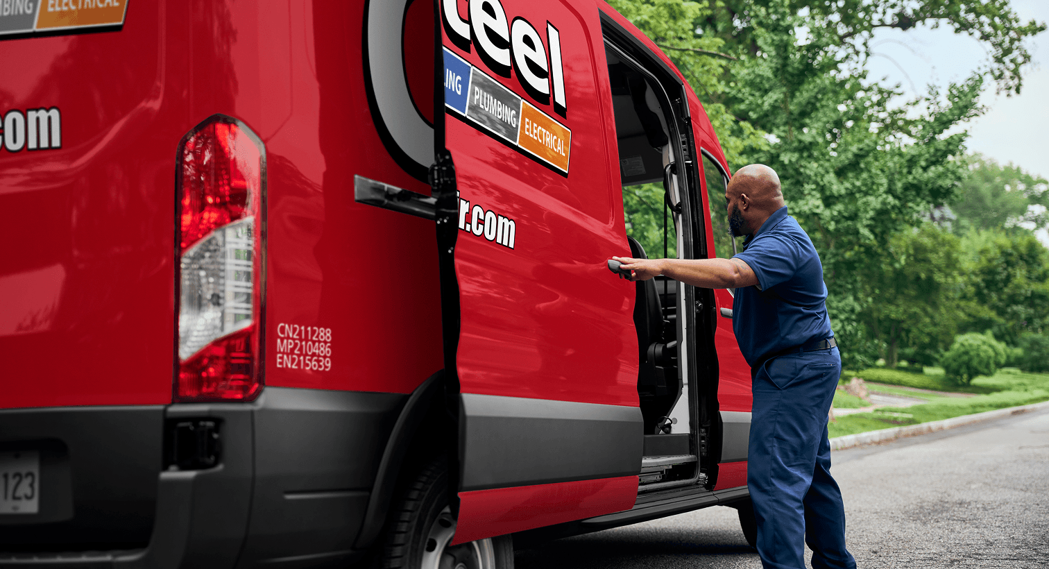 A professional Casteel technician opening a red service van on a residential street, ready to provide home HVAC, plumbing, and electrical services.
